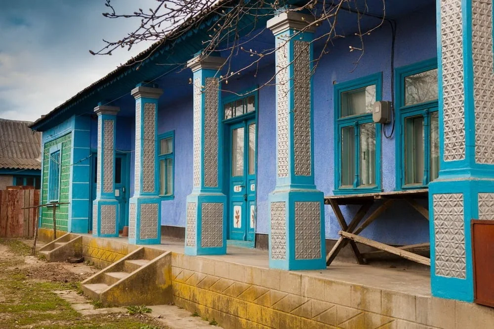 Traditional blue house with a covered porch — client photograph